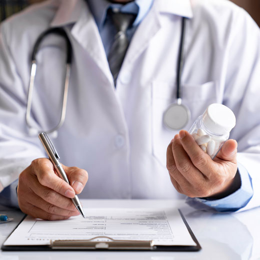 Doctor Filling Out Prescription Doctor Filling Out Prescription